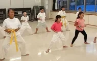 四股立ちという空手の基本の立ち方を練習中の小学生たち